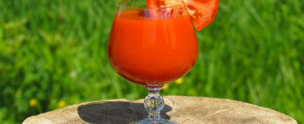 Sok pomidorowy w plasterkiem świeżego pomidora w kieliszku