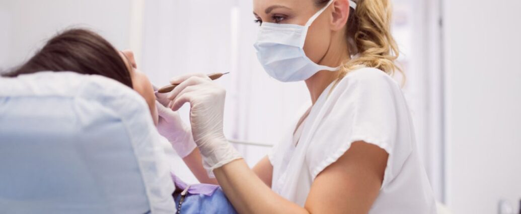Dentystka leczy zęby pacjentowi w gabinecie