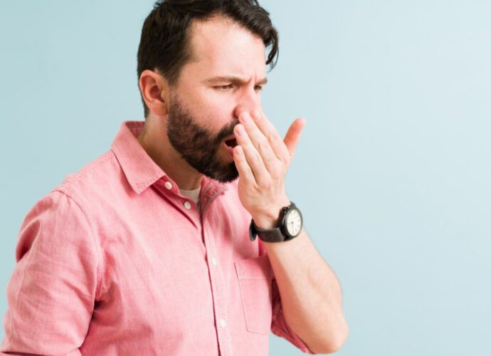 Mężczyzna sprawdza zapach z ust