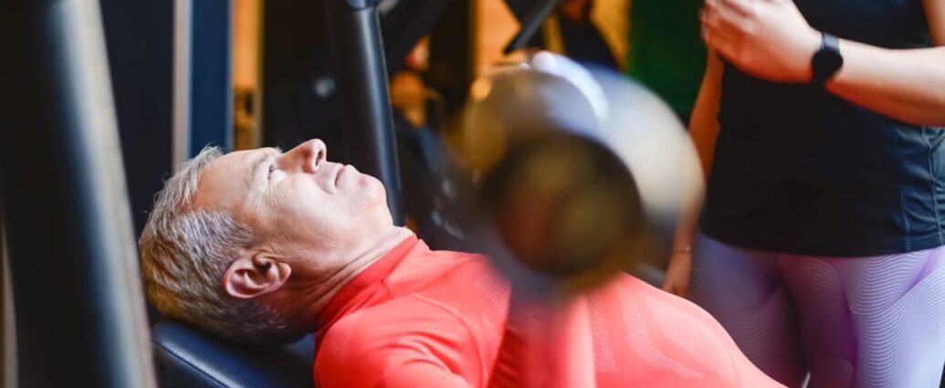 Starszy mężczyzna w czasie treningu na siłowni