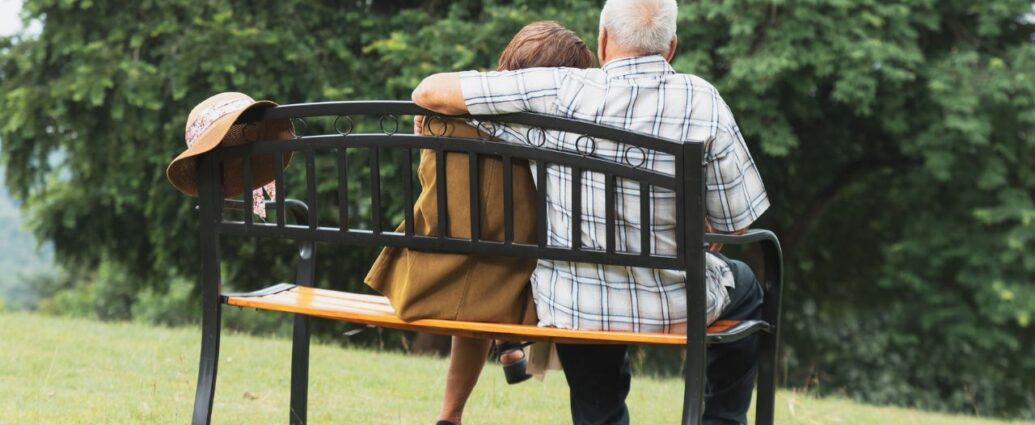 Para seniorów siedzących na ławce w parku